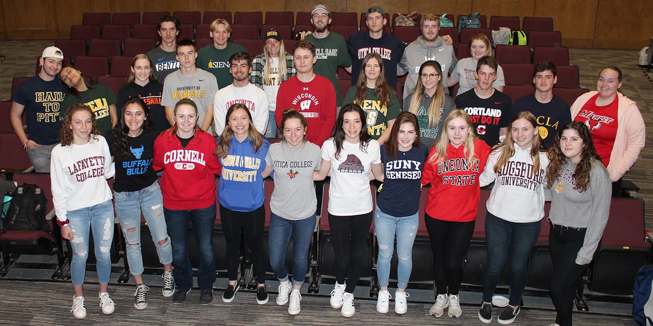 Ambitious students reviewing college applications with a mentor